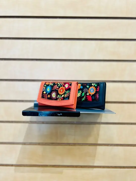 Embroidered leather wallets in coral and black