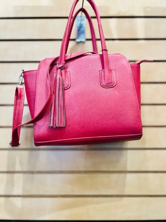 Pink leather handbag with tassel and shoulder strap